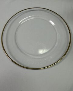a clear glass plate with a gold rim