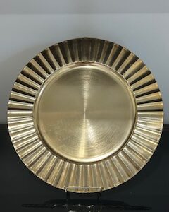 a gold plate with a scalloped edge
