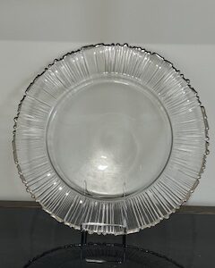 a clear glass plate with a silver rim