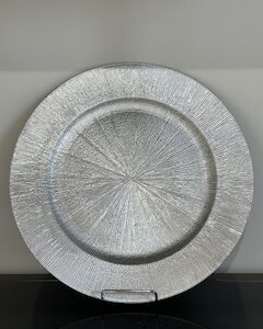 a silver plate on a shelf