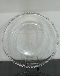 a clear glass bowl with a metal clip