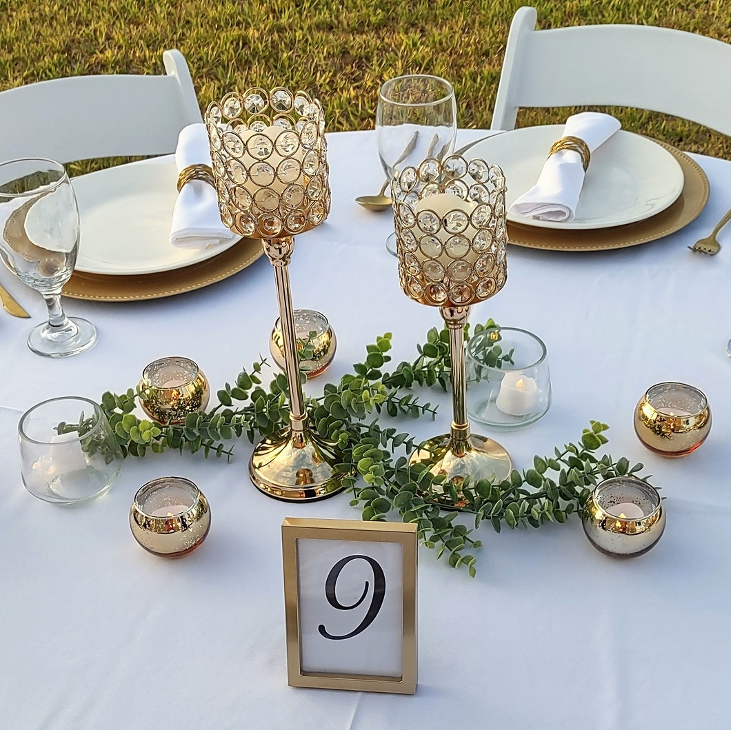 Elegant wedding table setup with white linens, gold chargers, and floral centerpieces – SWFL Wedding & Event Rentals